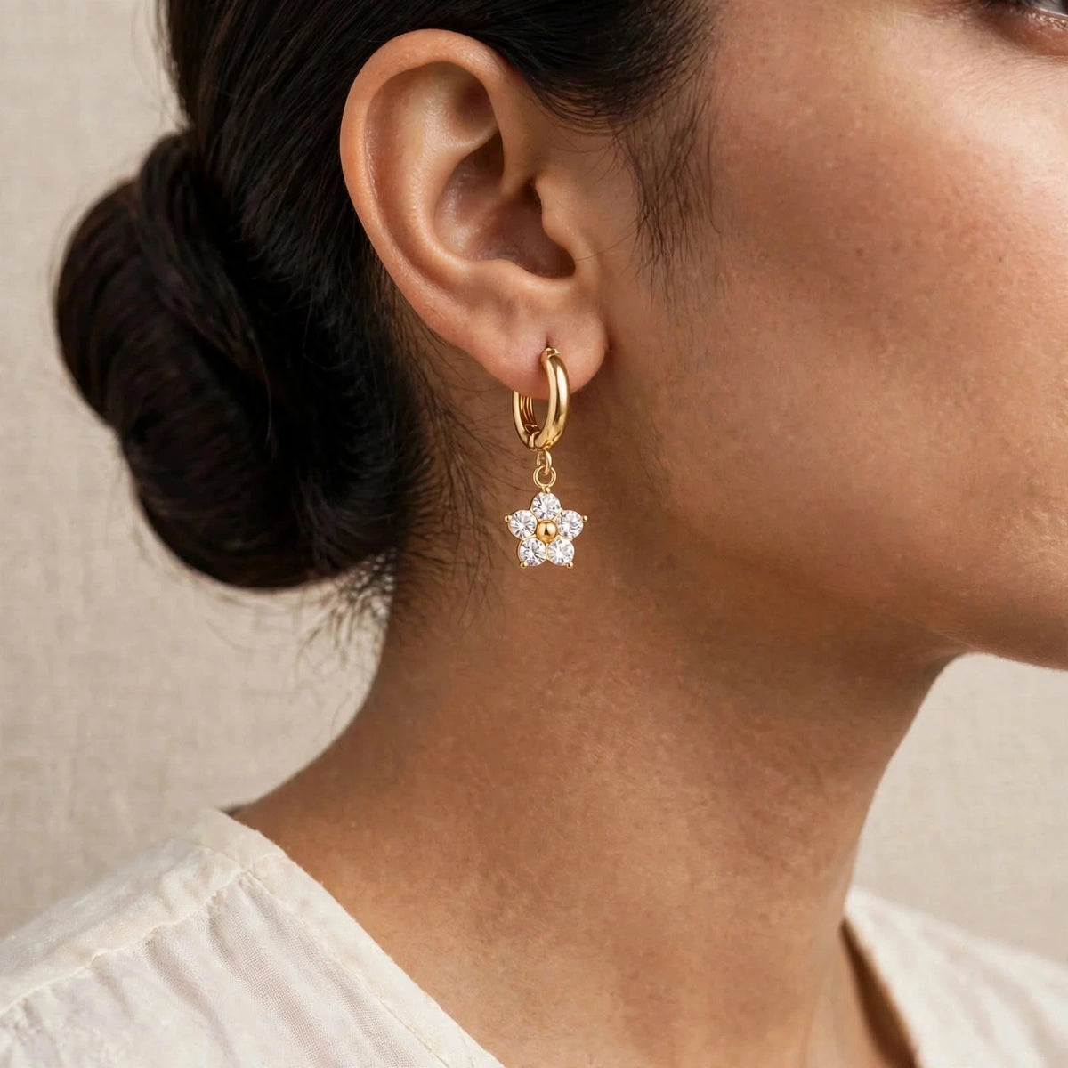 Indian model ear with small white zircon flower gold huggie close crop