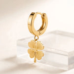 Side profile of gold clover drop earring showing depth on clear riser