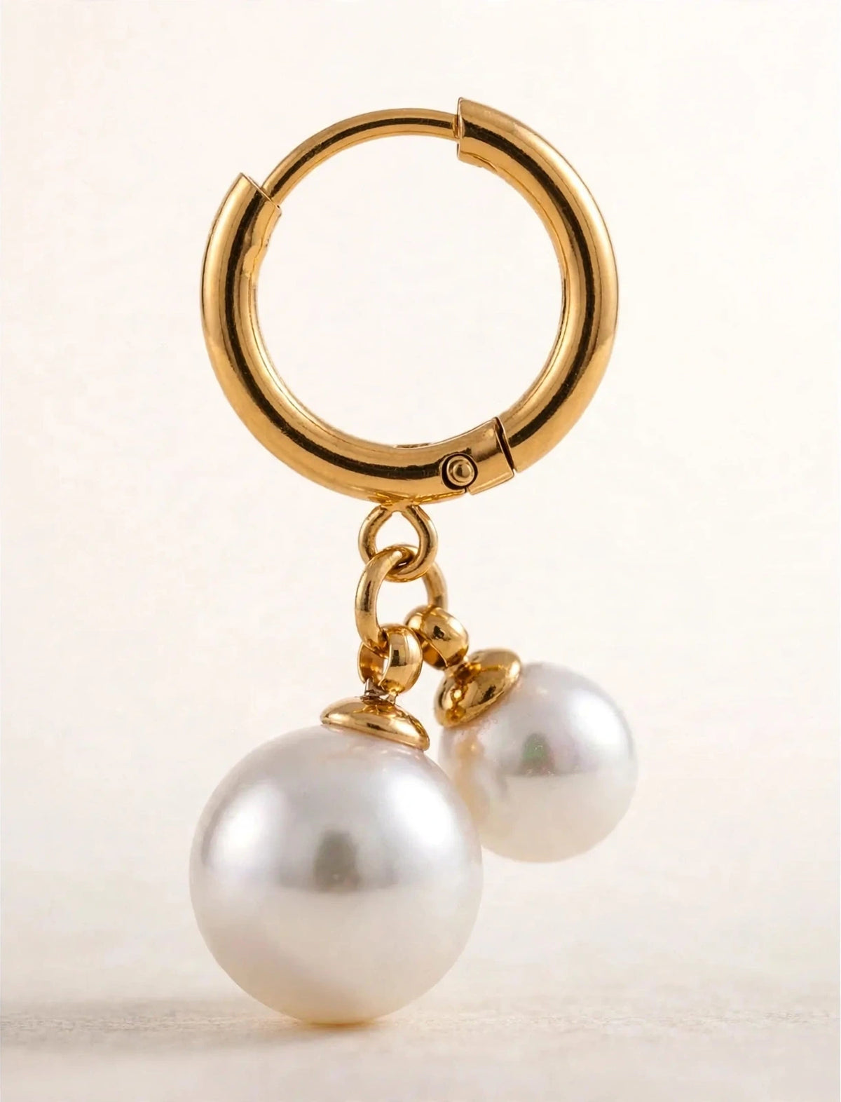 Huggie hoop clicker earring with double pearl drop macro detail