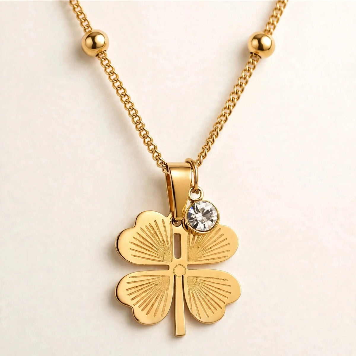 Gold clover pendant with crystal charm, chain bead removed on left side