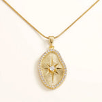 Gold sunburst oval pendant on snake chain