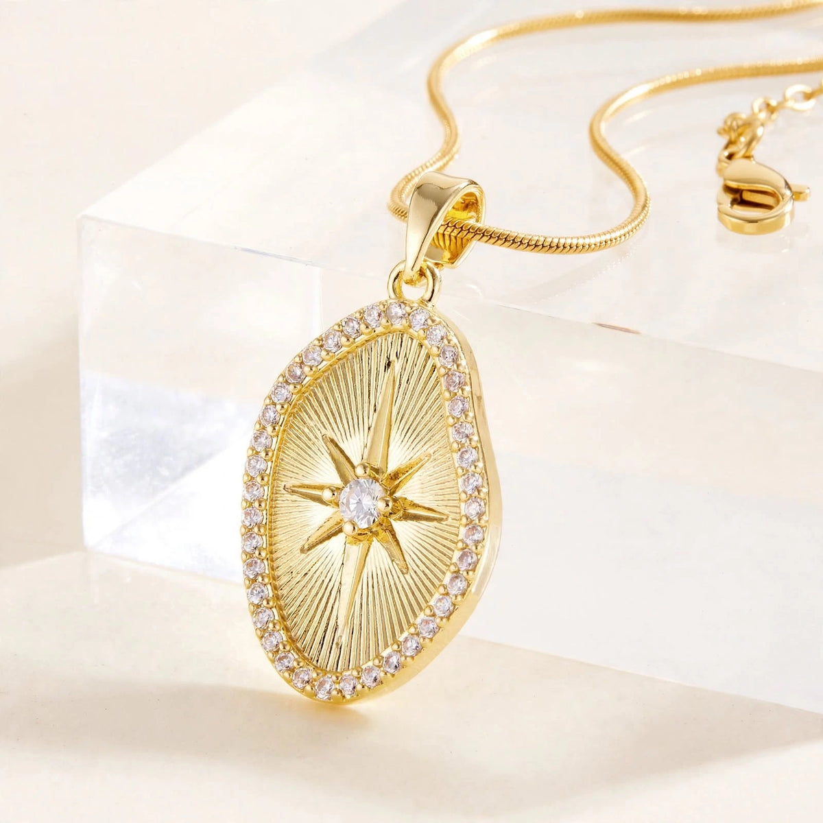 Side profile of gold sunburst pendant on invisible riser showing thickness and depth