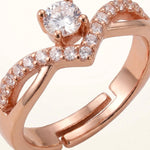 Extreme macro of rose gold V ring with central solitaire and pave stones showing open band