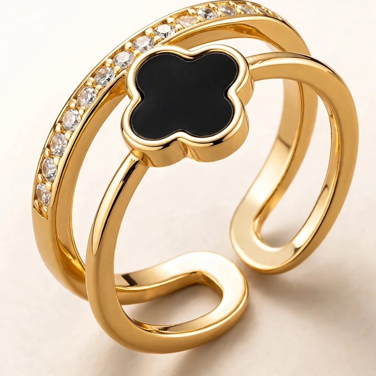 Extreme macro close-up of black clover gold ring showing crystal details
