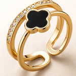 Extreme macro close-up of black clover gold ring showing crystal details