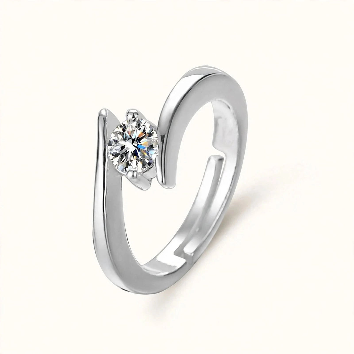Silver adjustable open bypass ring with round diamond solitaire floating on off-white.