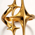 Extreme macro of gold triple star ring top showing open ends and polished detail