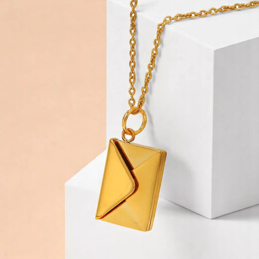 Necklace on a white geometric prop with a peach-colored gradient background.