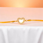 Bracelet on white nylon cloth with a peach-colored gradient in the background.