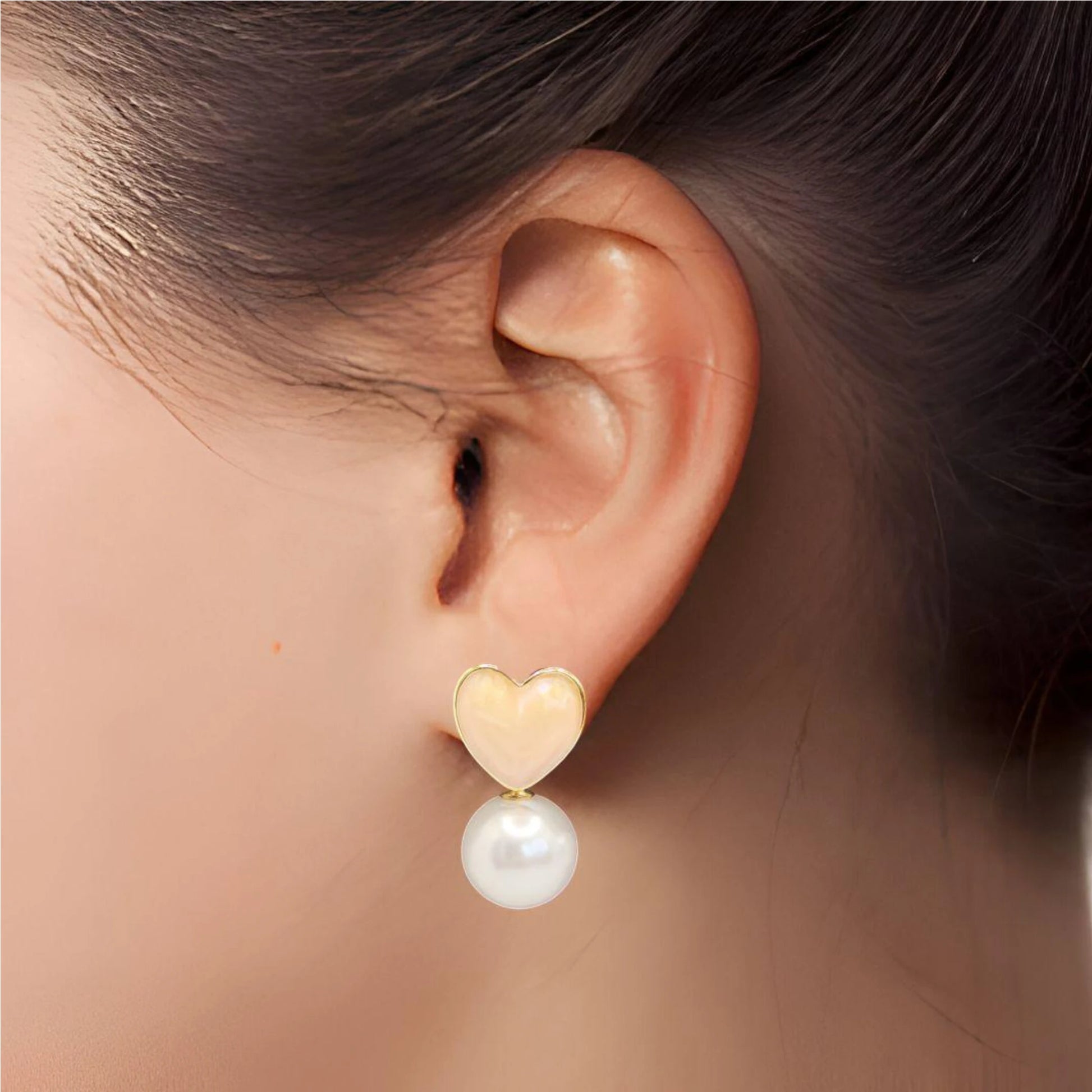 Pink Heart Pearl Drop Earrings worn by a model.
