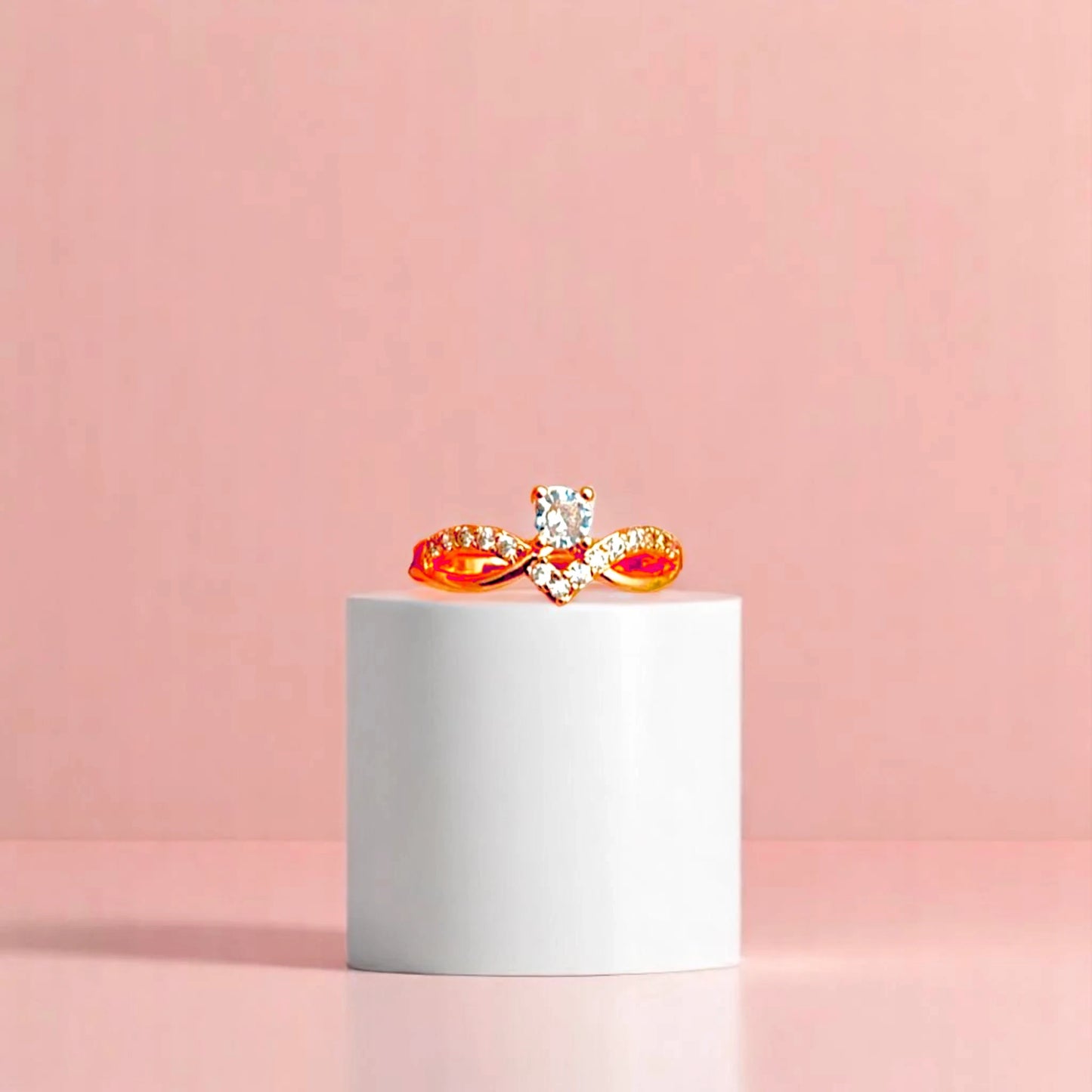 Ring on a white cylindrical geometric prop with a peach color gradient in the background.