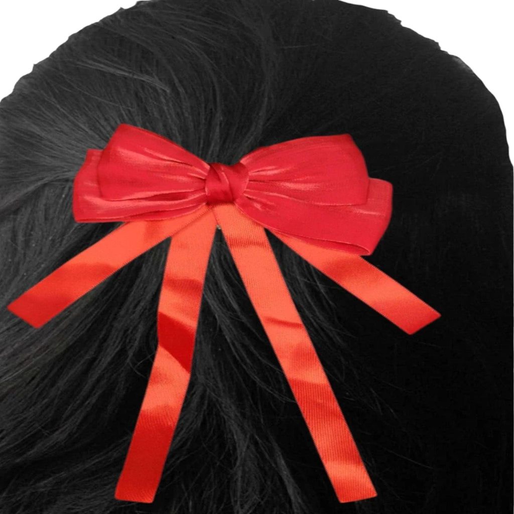 Red bow hair clip on black hair
