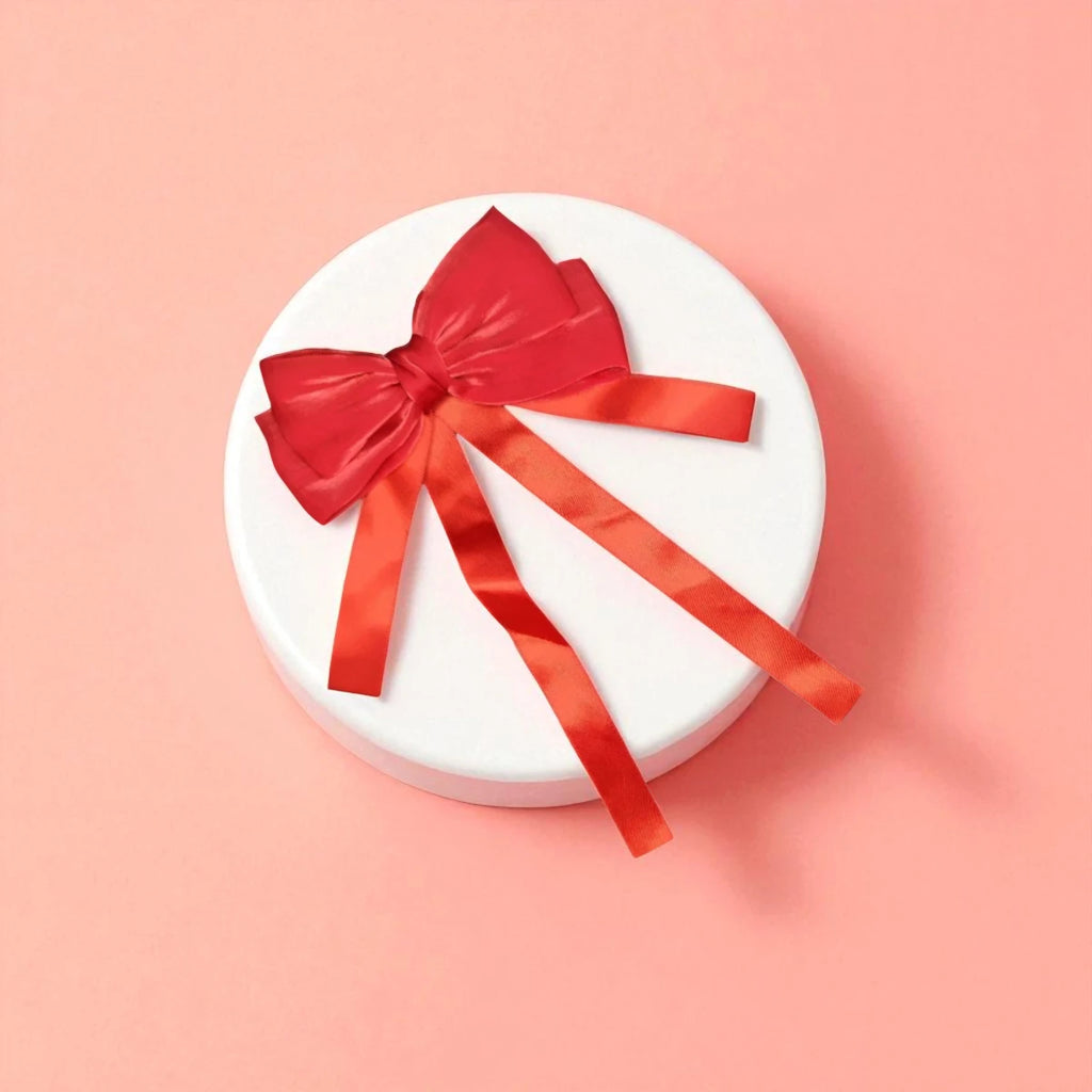 Round white acrylic pedestal with a Red bow on a light background