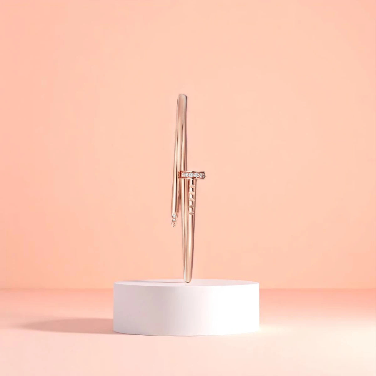 Bracelet displayed on a white pedestal against a soft peach background.