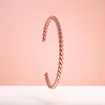 Bracelet on a color gradient of peach tones background.