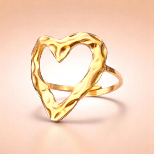 Ring on a color gradient of a peach-toned background.