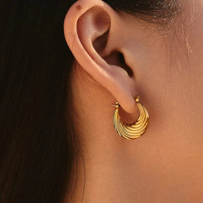 Sculpted Wave Hoop Earrings worn by a model.
