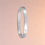 Bracelet on a color gradient of peach tones background.