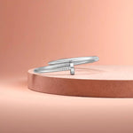 Bracelet displayed on a light-colored travertine stone slab with a peach-colored gradient in the background.