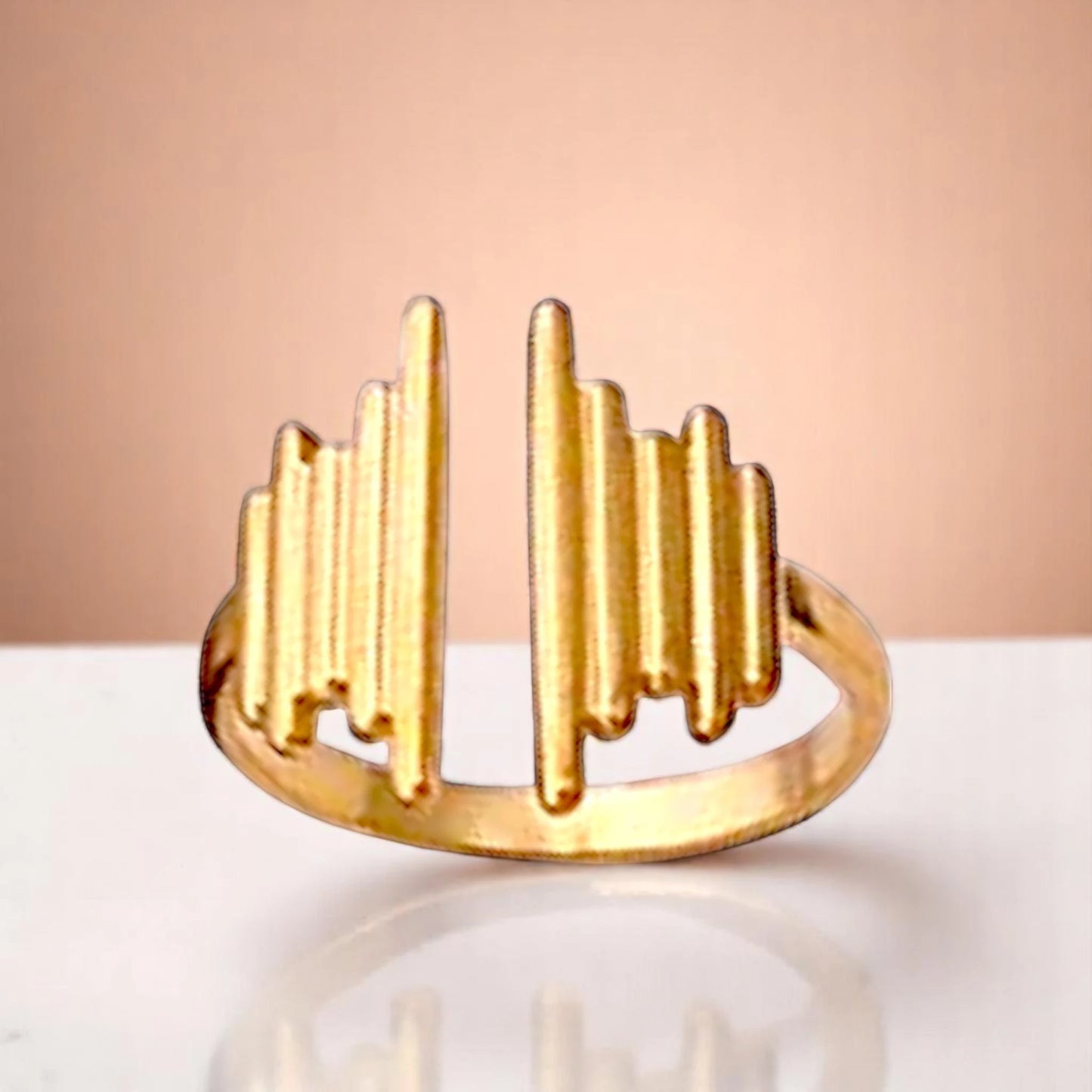 Ring on a color gradient of a peach-toned background.