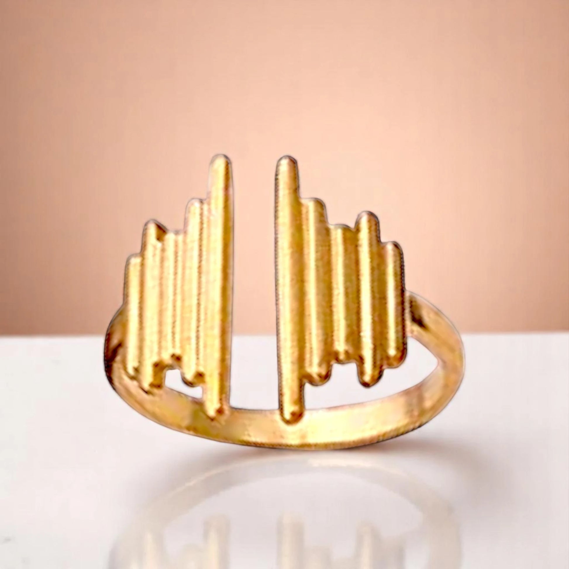 Ring on a color gradient of a peach-toned background.