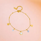 Anklet on a color gradient of peach tones background.