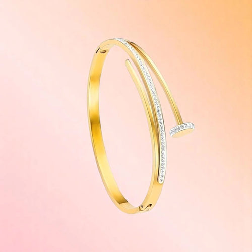 Bracelet on a color gradient of peach tones background.