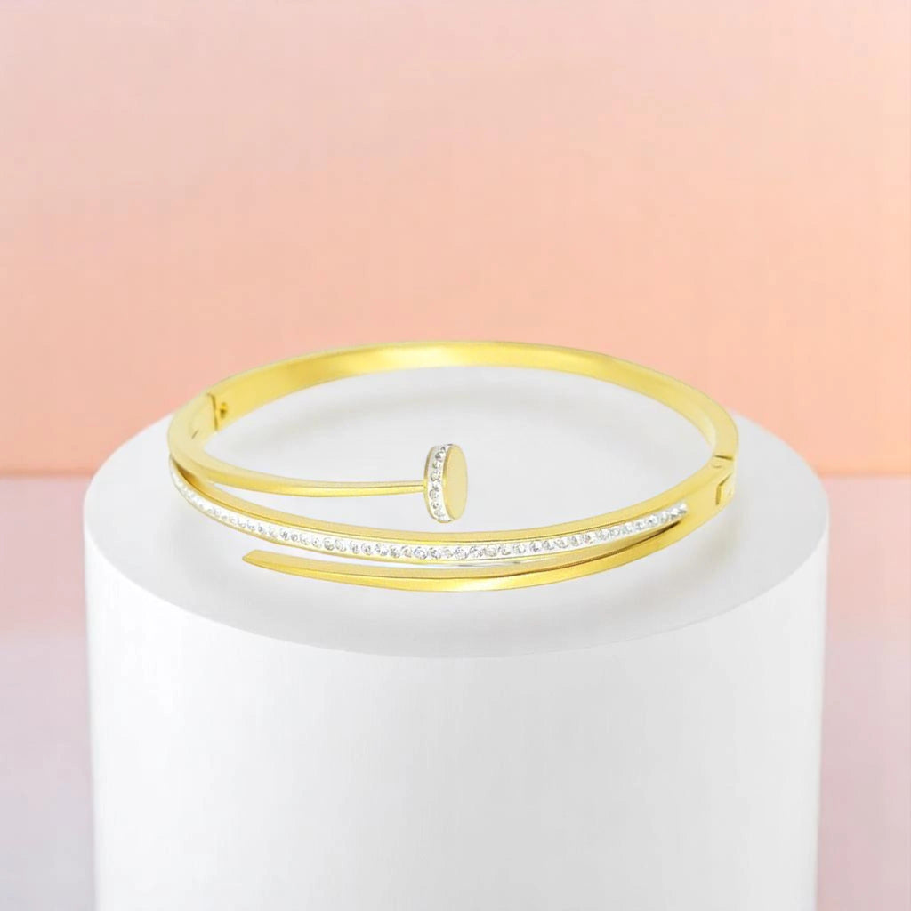 Bracelet on geometric prop with peach color gradient in the background.