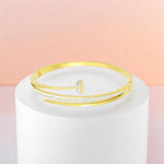 Bracelet on geometric prop with peach color gradient in the background.