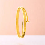 Bracelet on a color gradient of peach tones background.