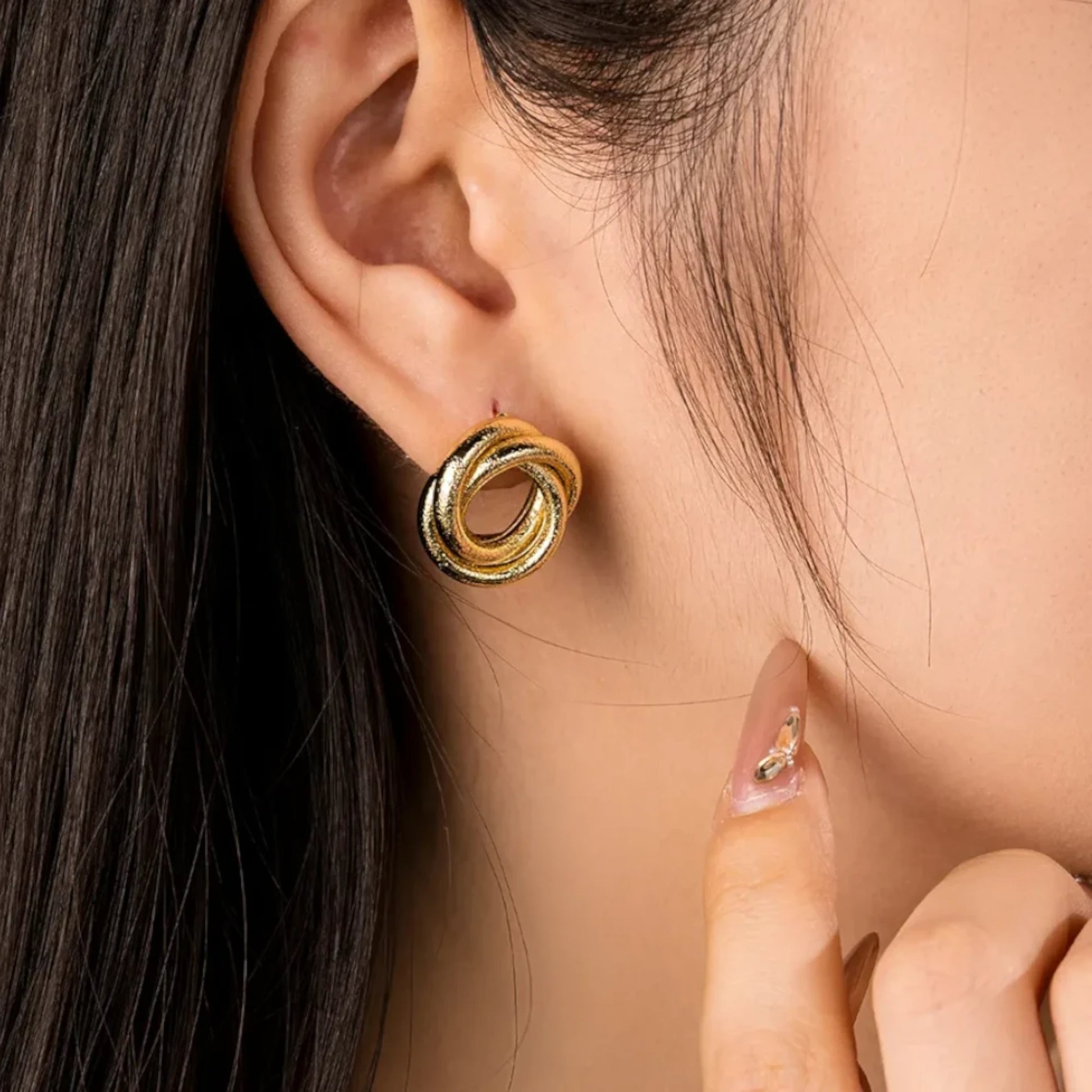 Twisted Stripe Stud Earrings worn by a model.