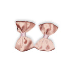 Two brown hair bows on a white background