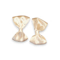 Two beige hair bows on a white background
