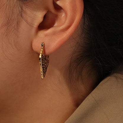 Wave-Patterned Hoop Earrings worn by a model.