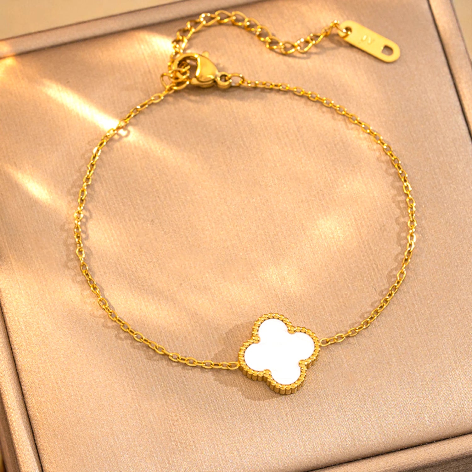 Bracelet on a soft fabric box with a light-toned background.