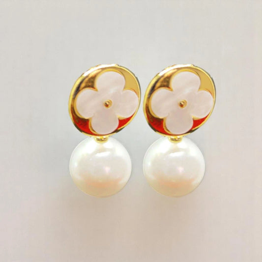 Elegant gold and white pearl earrings featuring a floral design with a glossy finish. Perfect for any occasion.