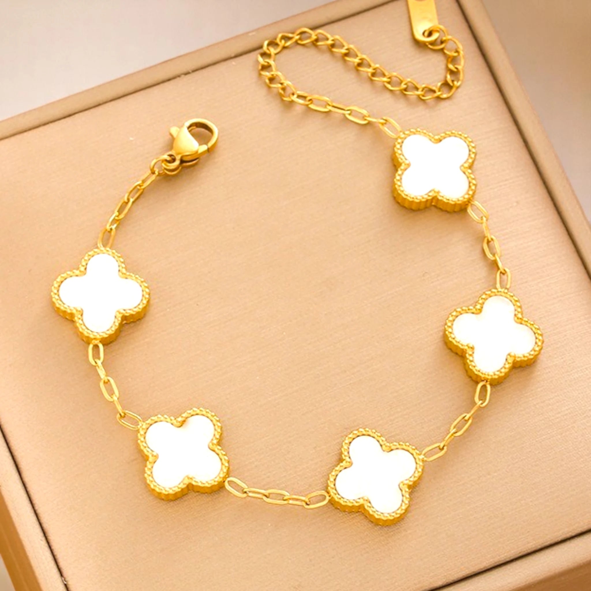 Bracelet on a soft fabric box with a light-toned background.