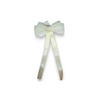 White bow with ribbons on a white background