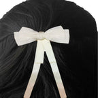 White bow hair clip on black hair