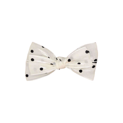 White bow tie with black polka dots on a white background
