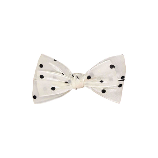 White bow tie with black polka dots on a white background